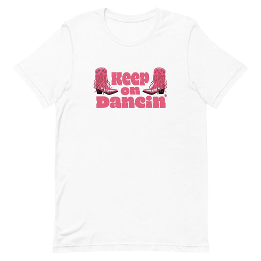 &#39;Keep on Dancin&#39;&#39; with illustrated pink cowboy boots. Inspired by Chappell Roan’s vibrant, upbeat style, this tee is perfect for country music lovers, festival-goers, and fans of retro-inspired pop culture fashion.